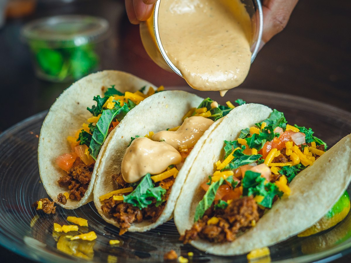 Crema poured over tacos